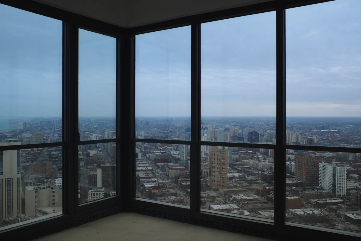 Window wall of a high-rise condominium unit overlooking Chicago, Illinois