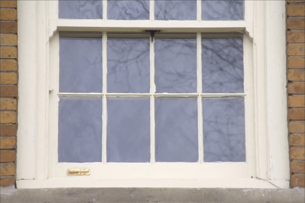 Divided-light wood double-hung window on a brick house in Chicago, Illinois