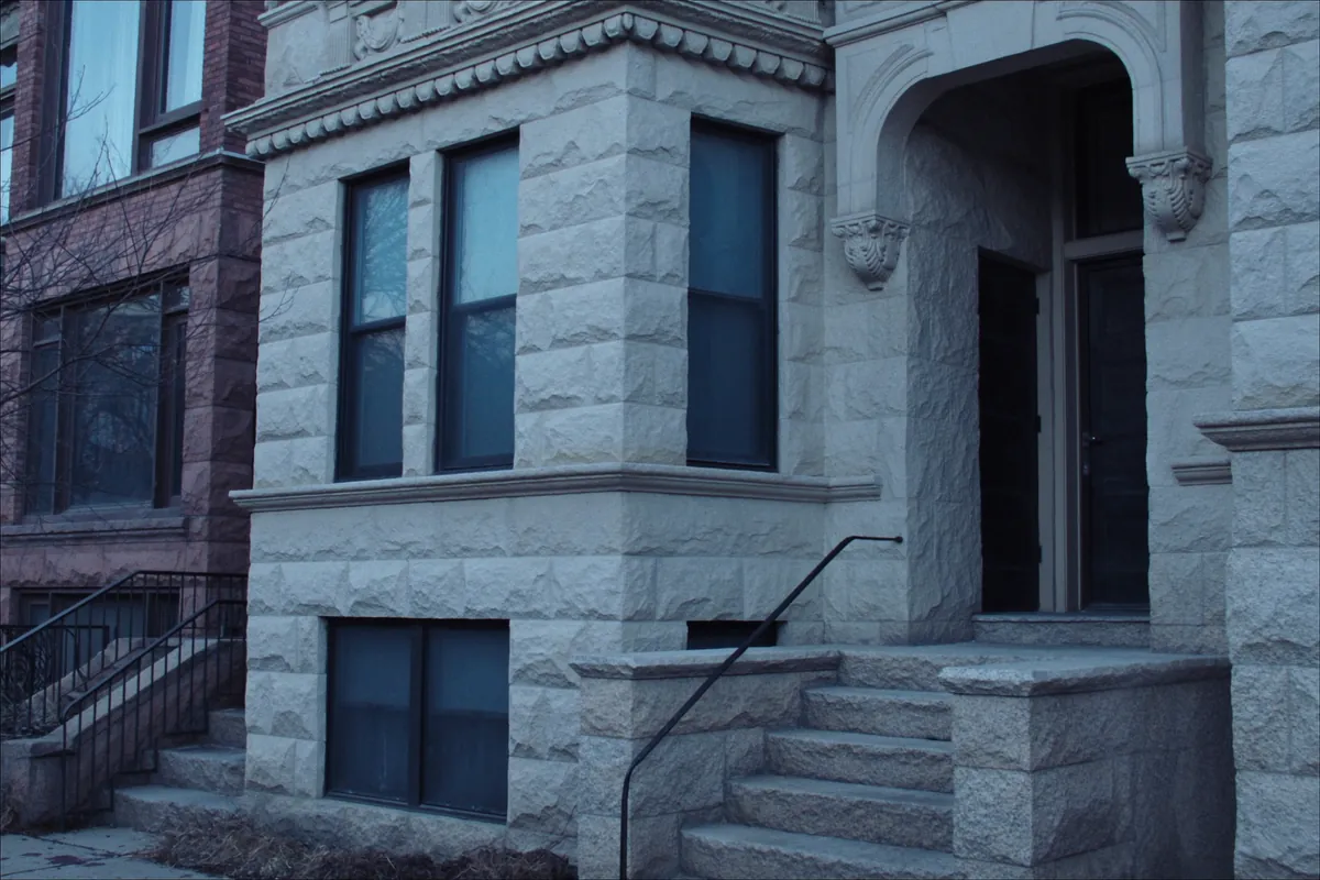 Limestone greystone facade with a bay window in Chicago, Illinois